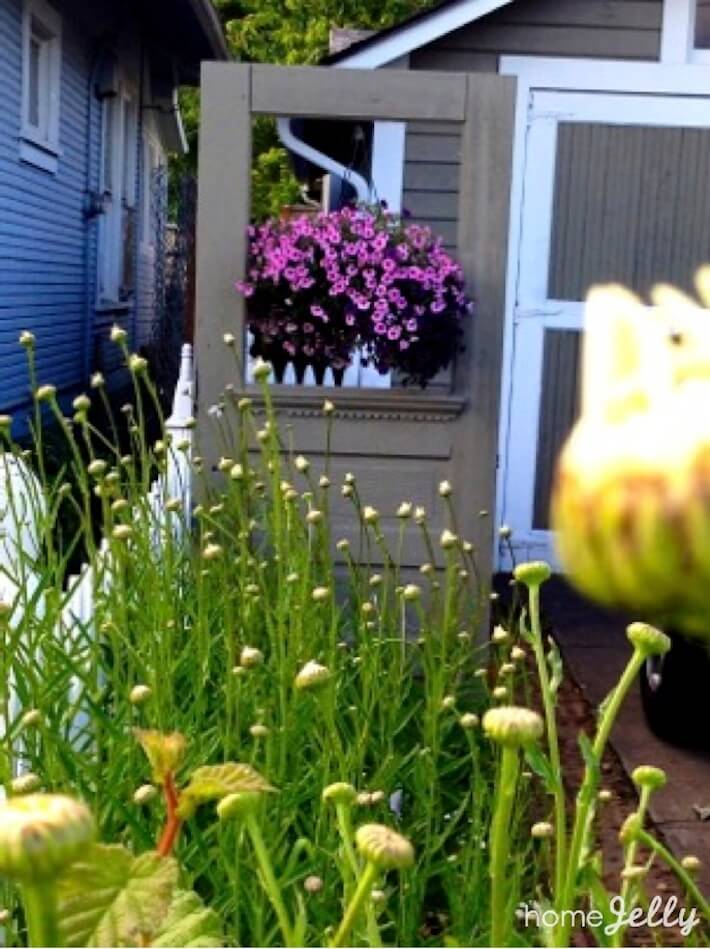 Repurposed Vintage Door Cleverly Hides Trash Cans HomeJelly
