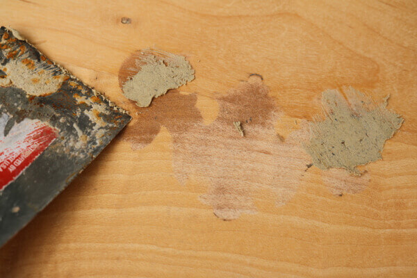 Fill old hardware holes with wood putty, then sand smooth