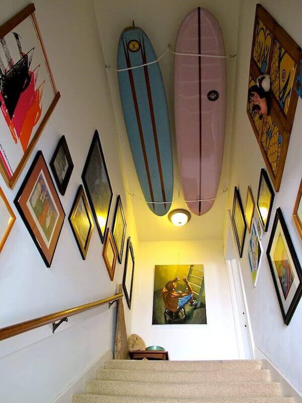 Staircase gallery with surfboard ceiling