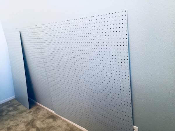 Temporarily mount pegboards on wall