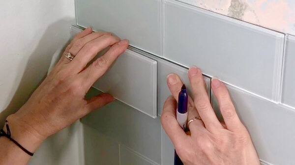 Place spare tile (B) against wall and over tile (A)