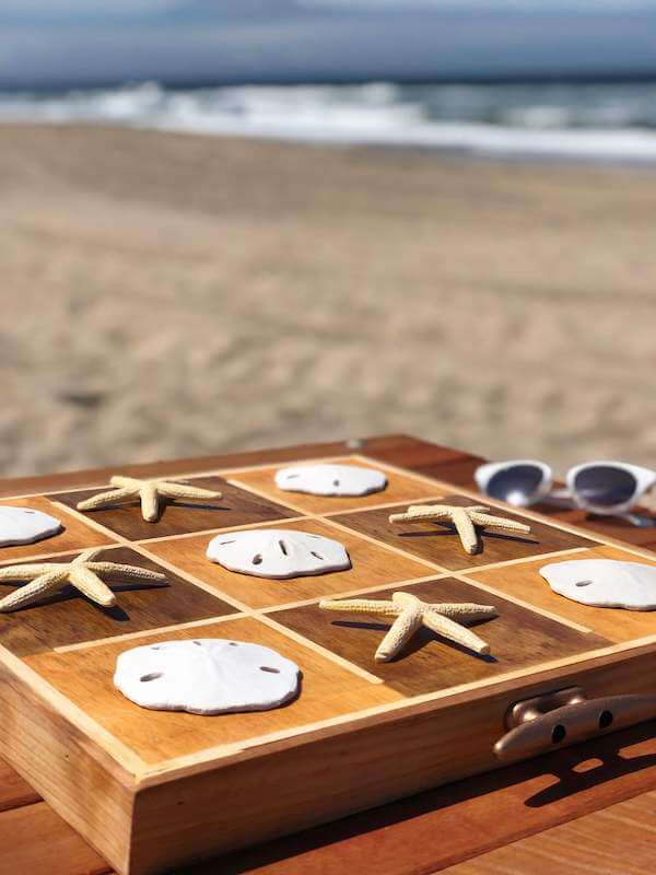 DIY wooden coastal Tic-Tac-Toe board angle to water