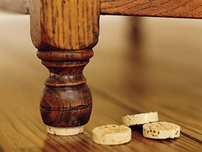 https://www.homejelly.com/wp-content/uploads/2013/02/Wine-cork-furniture-stablizer1-e1361323910527.jpg