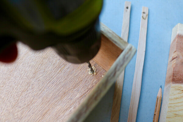 Measure, then drill hole in drawer