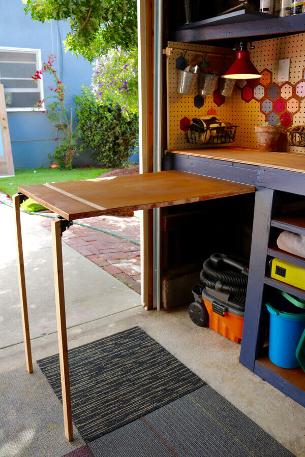Add extra work space (along with hiding away shop vac) with this folding table