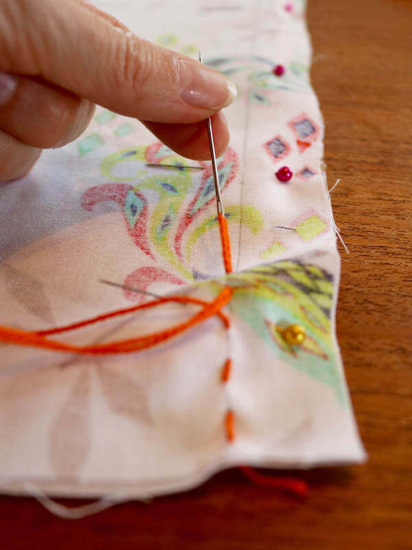 If you don't have a sewing machine, hand stitch a stright stitch using embroidery thread