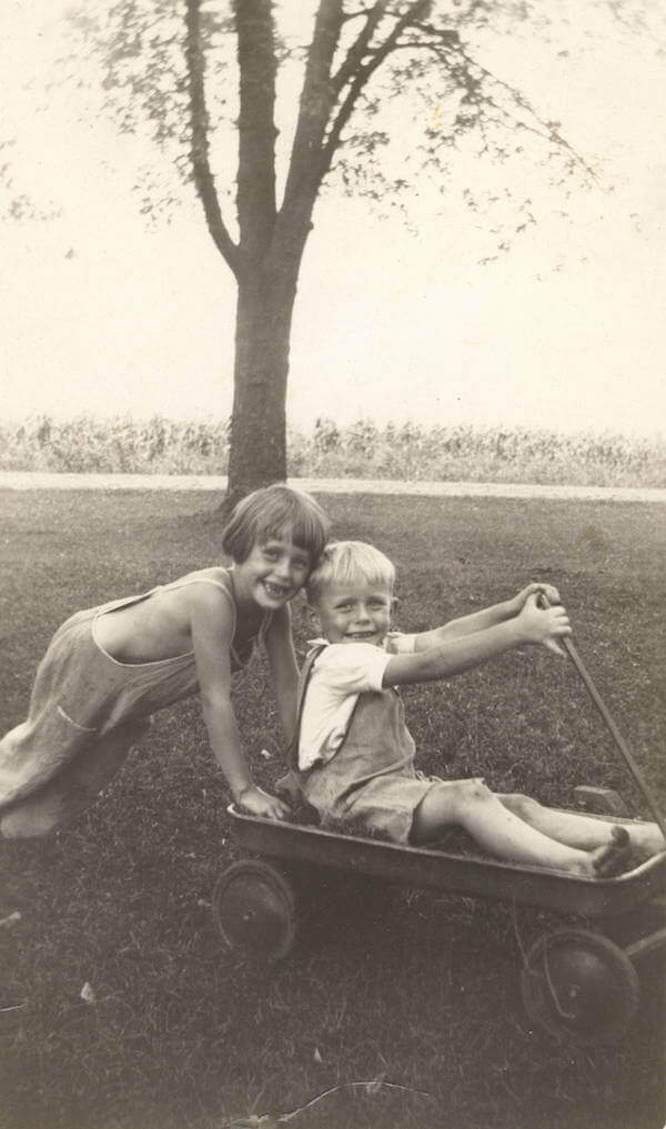 Lois and her younger brother, Dick, playing on their family farm, circa 1937