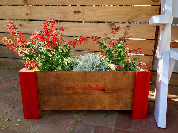 DIY'd flower box out of scrap wood with welcome sign
