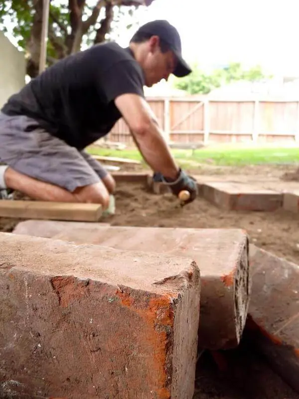 Tapping the brick pavers we found on DiggersList