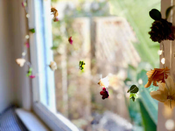 Lighted flower garland hangs so prettily at a window