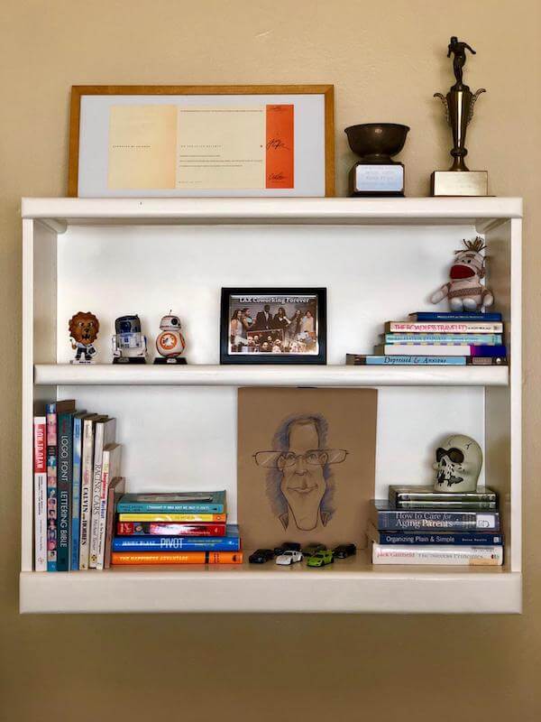 Styled bookcase with cherished awards, photos, artwork, books and fun knick-knacks is both fun and functional