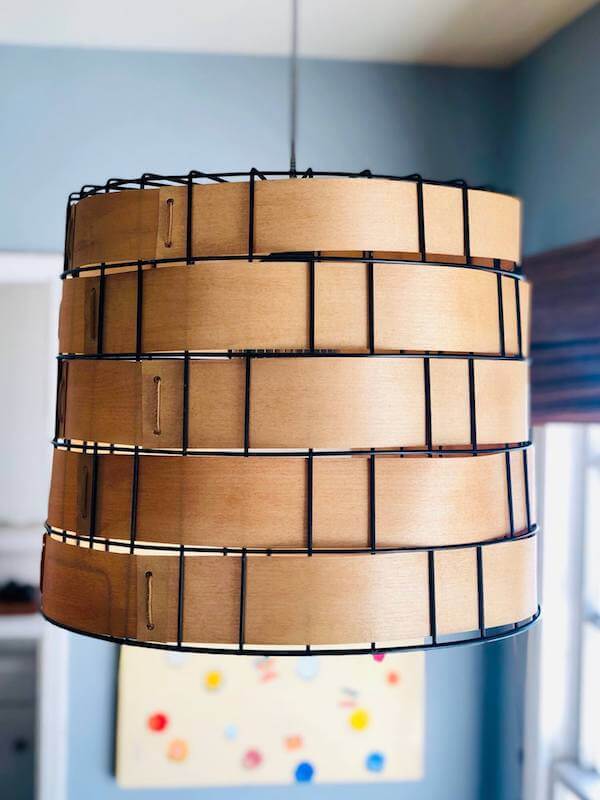 Repurposed metal basket swag light hanging in our dining room