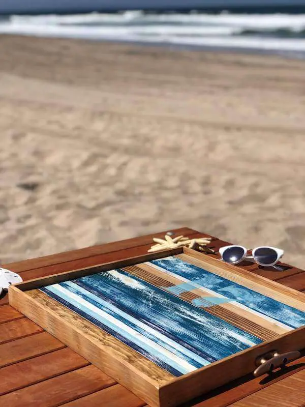 Wooden coastal serving tray on the flip side at the ocean side