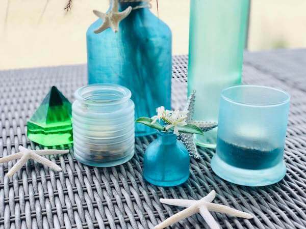 DIY Sea Glass bottles, votives and vases closeup horizontal