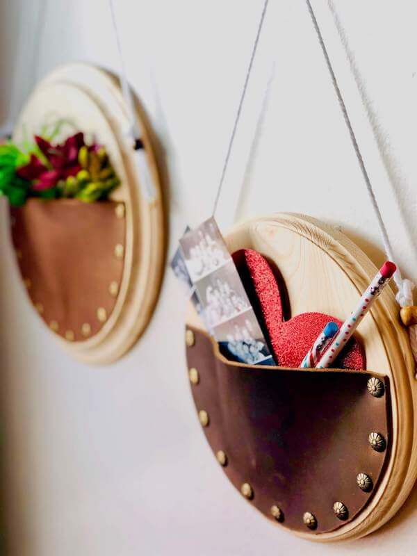 leather wall hangings with items inside